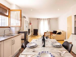 a kitchen and living room with a dining room table at Casa Valentina in Dúrcal