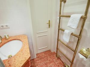 a bathroom with a sink and a towel rack at Fernsicht in Morsum