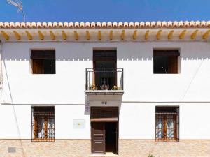 a white building with windows and a balcony at Casa Valentina in Dúrcal