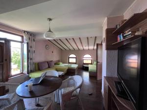 a living room with a couch and a table at BRUNETTE BEAUTIES Guesthouse & Studio Sinemorets in Sinemorets