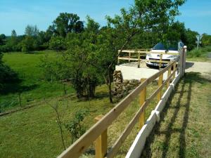 a wooden fence with a boat on a trailer at la petite maison d'Albert in La Motte-Saint-Jean