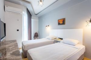 Postel nebo postele na pokoji v ubytování Aslan Sand & City Hotel