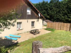 een huis met een picknicktafel en een bank in de tuin bij Gite de la cascade in Les Planches-près-Arbois