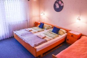 1 dormitorio con 1 cama grande con almohadas azules en Guest House Ivanka, en Bled