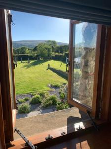 a window with a view of a green field at Gooseford Farm in Okehampton