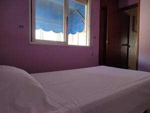 A bed or beds in a room at Apartamentos Casa May III - Centro Benidorm