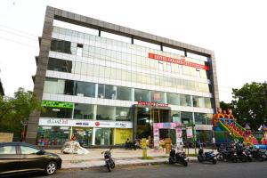 a large building with motorcycles parked in front of it at HOTEL GOLDEN CITY in Surat