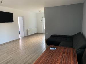 a living room with a couch and a table at Casa Lucas si Rafael in 2 Mai
