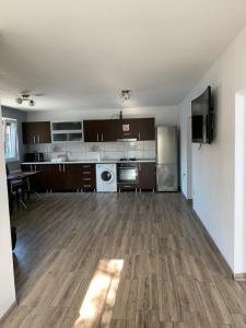 an empty room with a kitchen and a living room at Casa Lucas si Rafael in 2 Mai