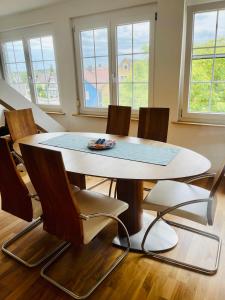 a table and chairs in a room with windows at Apartments Sunny Place in Rust
