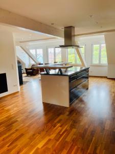 a living room with a table and a wooden floor at Apartments Sunny Place in Rust