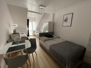 a bedroom with a bed and a table and a desk at Dom gościnny Jarek in Rowy
