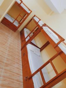 two bunk beds in a room with a ceiling at Pamujo Hostel in Baclayon