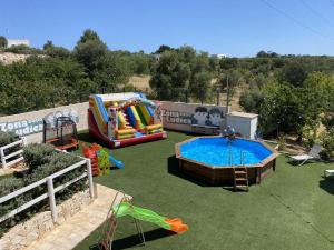 an outdoor playground with a water slide and a pool at Relais Il Trullo della Rupe in Ostuni