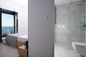 a bathroom with a bed and a shower and a sink at Mirazur Seafront Sunset Villa in Preveza +66 photos