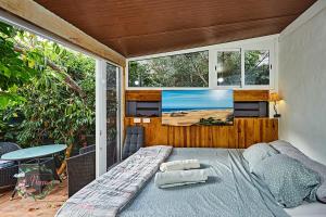 a bedroom with a bed and a large window at Finca OASIS Fataga in Maspalomas +83 photos