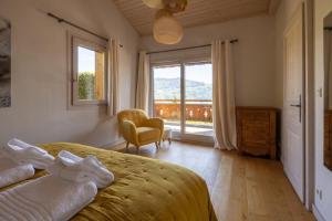 a bedroom with a bed and a large window at Chalet Taninges in Taninges