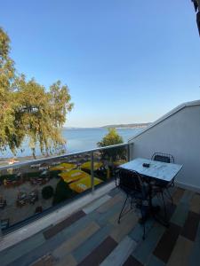 a balcony with a table and a view of the ocean at Burla Han in Urla