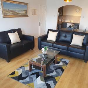 a living room with two couches and a coffee table at Arch House B&B & Apartments in Athlone