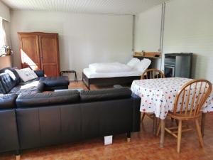 a living room with a couch and a table and a bed at Van Horick in Baal