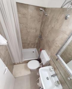 a bathroom with a toilet and a shower and a sink at Mari in Opatija