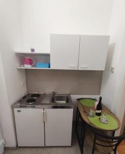 a small kitchen with a sink and a table at Mari in Opatija +21 photos
