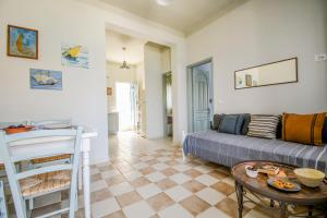 a living room with a couch and a table at Ponente in Symi