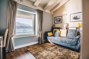 a living room with a couch and a window at Araba Fenice Hotel in Iseo