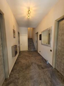 an empty hallway with stairs and a ceiling fan at Sea La Vie - Studios Maria in Limenaria