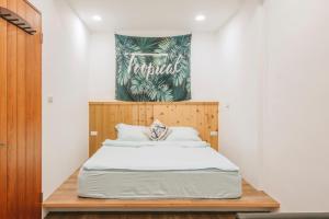 Postel nebo postele na pokoji v ubytování Wind Wave Ocean Homestay