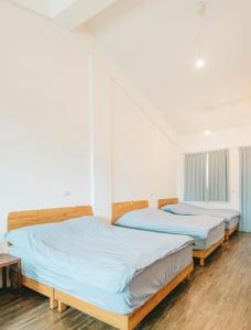 Postel nebo postele na pokoji v ubytování Wind Wave Ocean Homestay