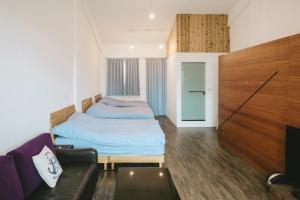 Postel nebo postele na pokoji v ubytování Wind Wave Ocean Homestay
