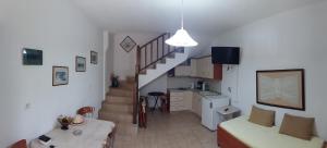a kitchen and a living room with a stairway at Stella Maisonettes in Ammouliani