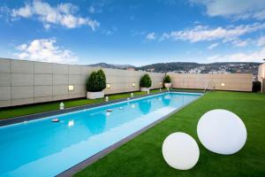 a swimming pool on the roof of a building at Hotel Andalucía Center in Granada