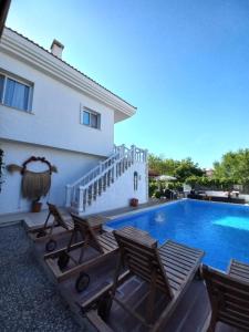 a villa with a swimming pool and a house at Alaçatı La Vista in Alaçatı
