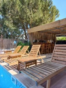 a group of wooden lounge chairs next to a pool at Alaçatı La Vista in Alaçatı