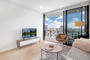 a living room with a view of a city at Lamour Ocean View Apartment I in Casino Broadbeach - free parking in Gold Coast