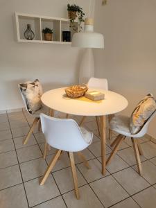 a table with two chairs and a table with a bowl on it at Ferienwohnung MIA in Flußbach