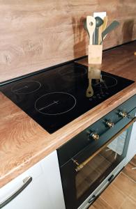 a stove top in a kitchen with a wooden counter top at Kod Dida in Gospić