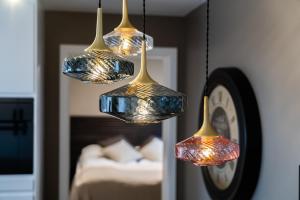 a group of four lights hanging from a clock at Keflavik Luxury apartment - KLA in Keflavík