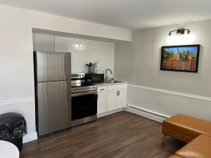 a kitchen with a stove and a refrigerator at Brooklyn Beach Club in Wildwood