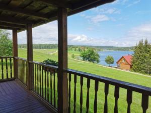 a view from the deck of a cabin with a view of a lake at Sodyba "Vytauto kaimas" Aukštadvaris in Aukštadvaris