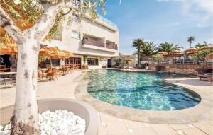 a swimming pool in front of a building at Nice Apartment In Saint-Cyprien in Saint-Cyprien