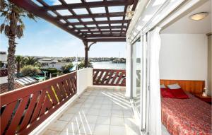 a balcony with a bed and a view of the water at Nice Apartment In Saint-Cyprien in Saint-Cyprien +14 photos