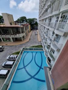 an overhead view of a swimming pool in front of a building at 2 to 6 pax Cityland Tagaytay Staycation NETFLIX WIFI COOKING SWIMMING POOL in Tagaytay