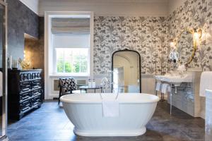 a bathroom with a large tub and a sink at The Queensberry Hotel in Bath +37 photos