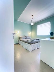 a bedroom with a bed and blue walls at Number 6 in Zakynthos Town