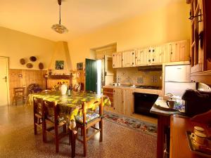 a kitchen with a table with a table cloth on it at La Bouganville B&B in Acconia