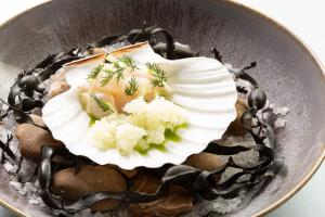 a dessert with a white flower on top of rocks at The Queensberry Hotel in Bath