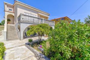 a large house with a balcony and stairs at NV Sun 23 by Aneo Travel in Novi Vinodolski